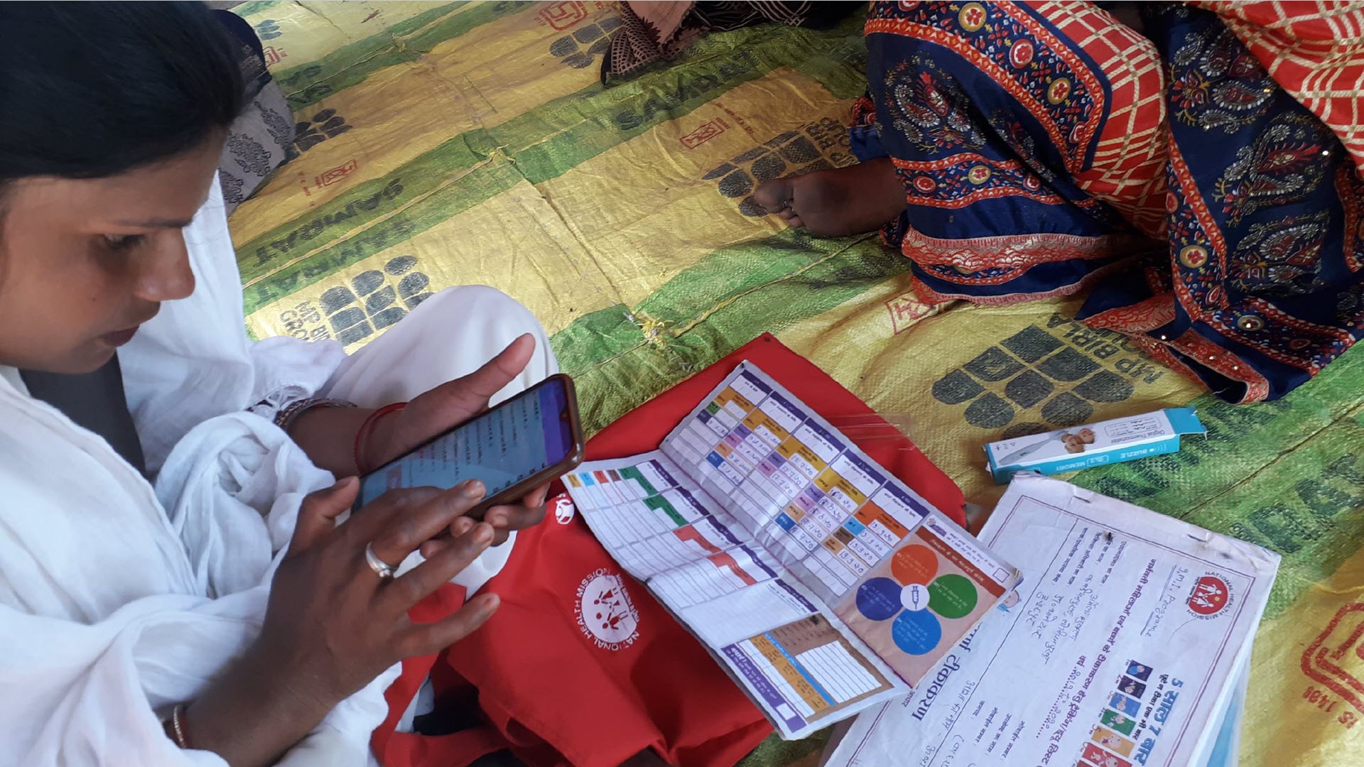 Health worker in a rural village in India using a mobile health education application